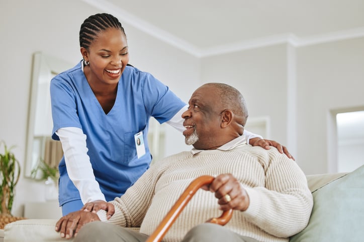 Professional home healthcare nurse with patient
